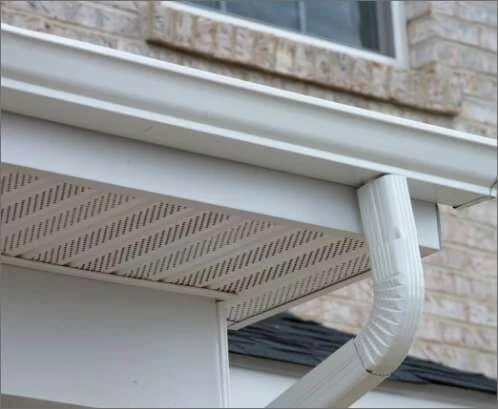A side view of a gutter and downspout.