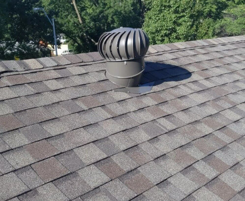 An asphalt shingle roof with attic exhaust ventilation installed by Bill West Roofing. 