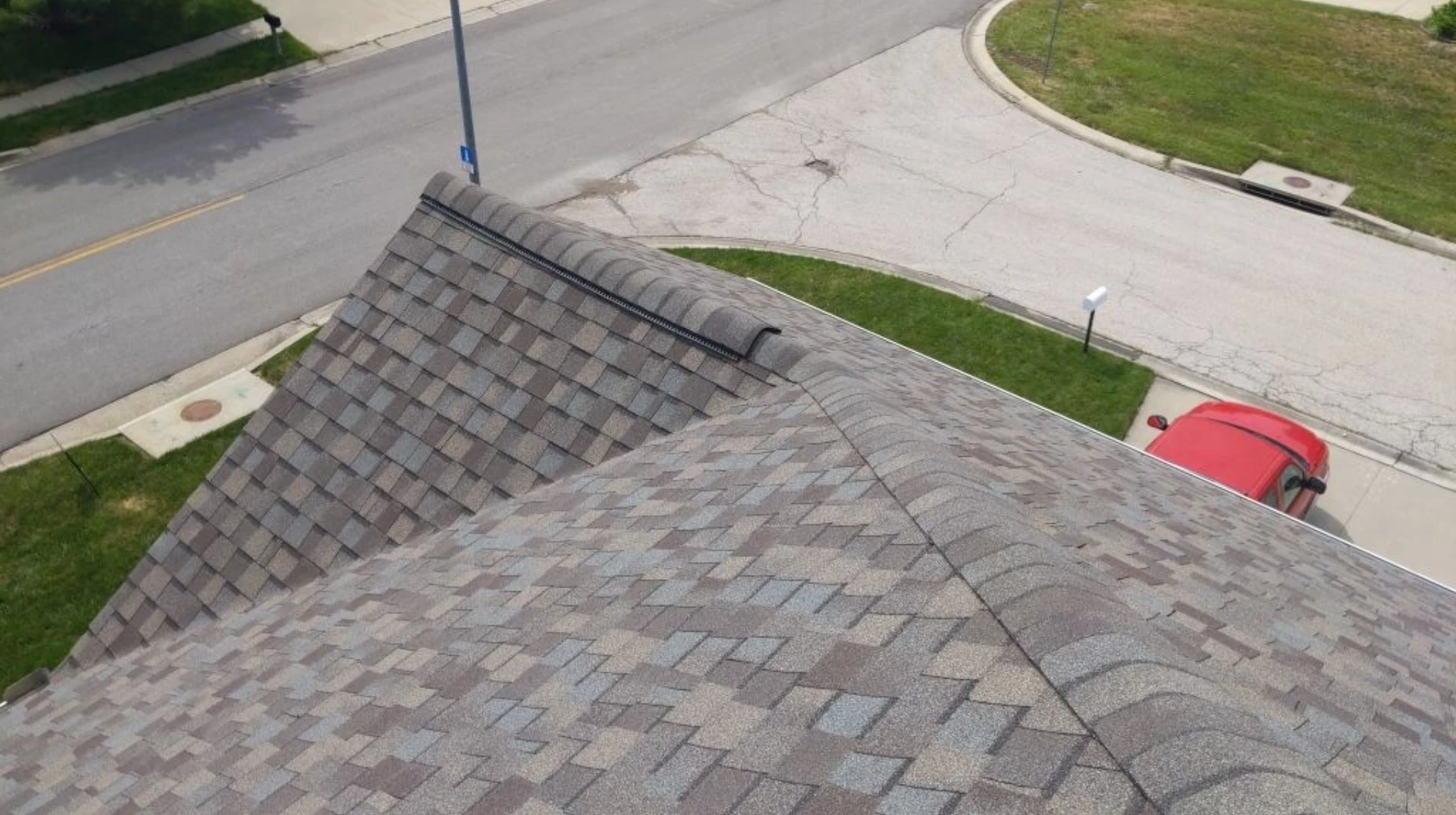 An overhead view of a home with asphalt shingles and a ridge vent installed by Bill West Roofing