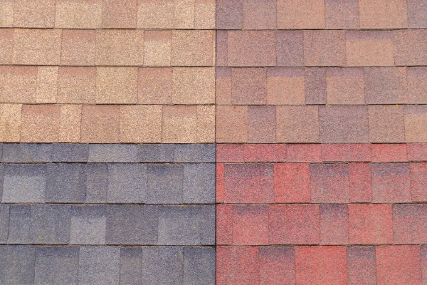Various asphalt shingle color samples showing potentially HOA-approved earth tone options for roof replacement